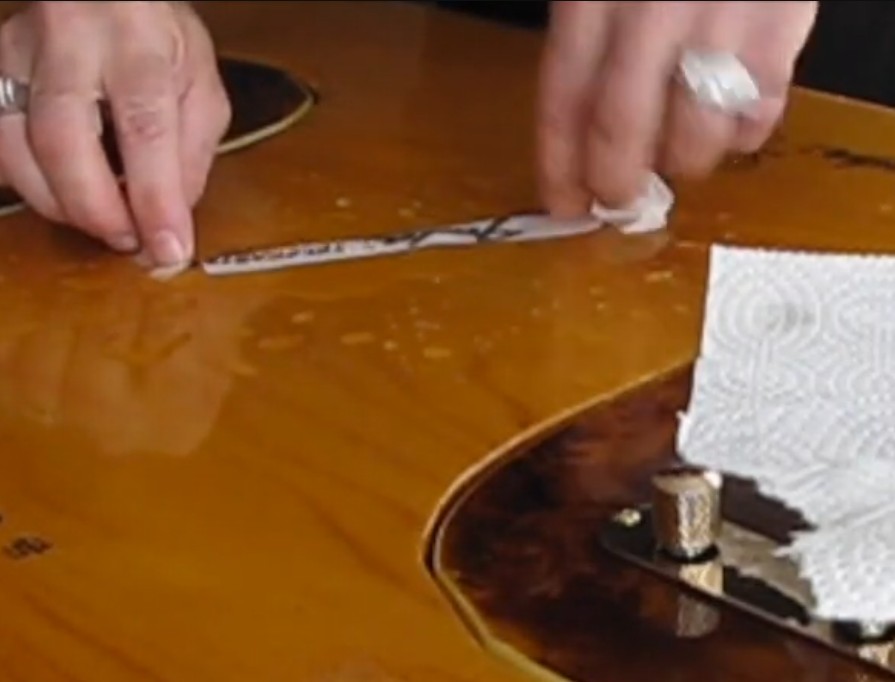 Applying a waterslide decal to a sunburst guitar body